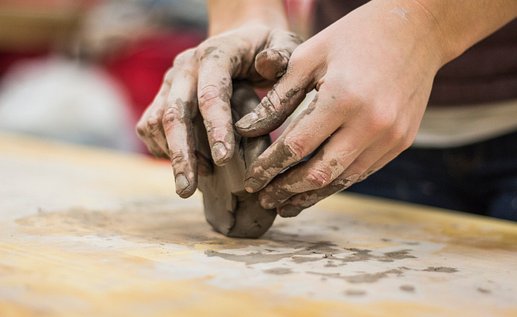 Hands modelling clay.